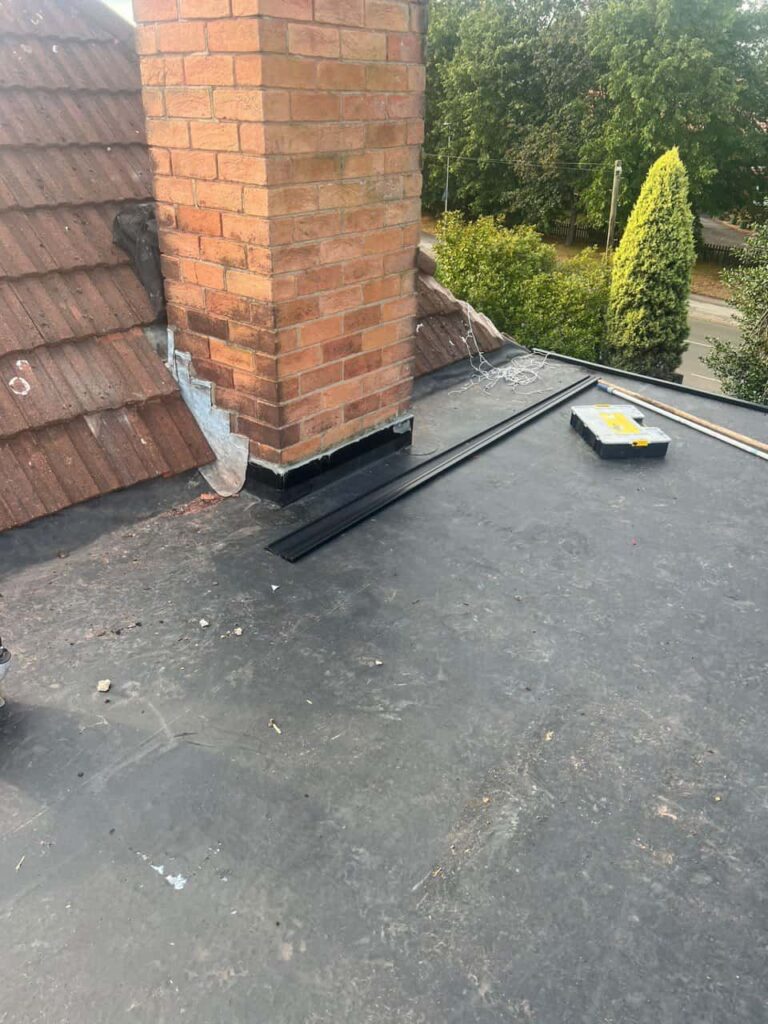 This is a photo of a flat roof which has just been repaired, there is also a chimney stack and some leadwork has also been dressed. Works carried out by Littleport Roofing Repairs